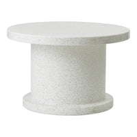 Round white speckled table with a smooth finish and cylindrical pedestal base. Ideal for modern decor.