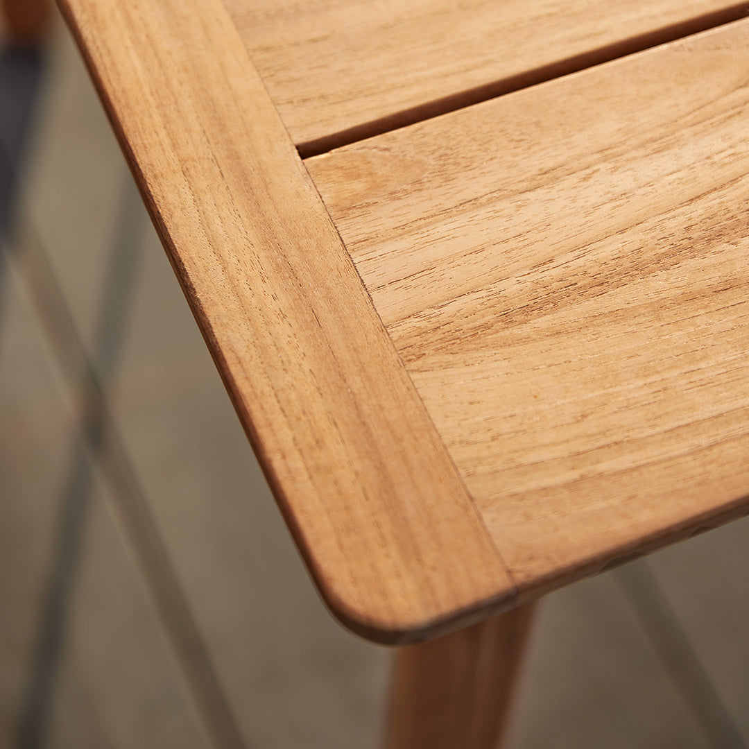 Natural wood table with light brown finish and subtle grain patterns, showcasing smooth edges and sleek design.