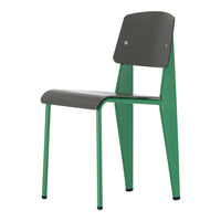 Stylish chair with a dark gray seat and backrest, featuring vibrant green legs. Modern design with sleek lines.