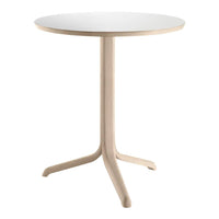 Round table with a smooth white top and light wood base, featuring a minimalist design and natural finish.