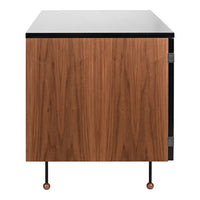 Wooden cabinet with walnut finish, black top, and minimalist metal legs. Modern design with natural patterns.