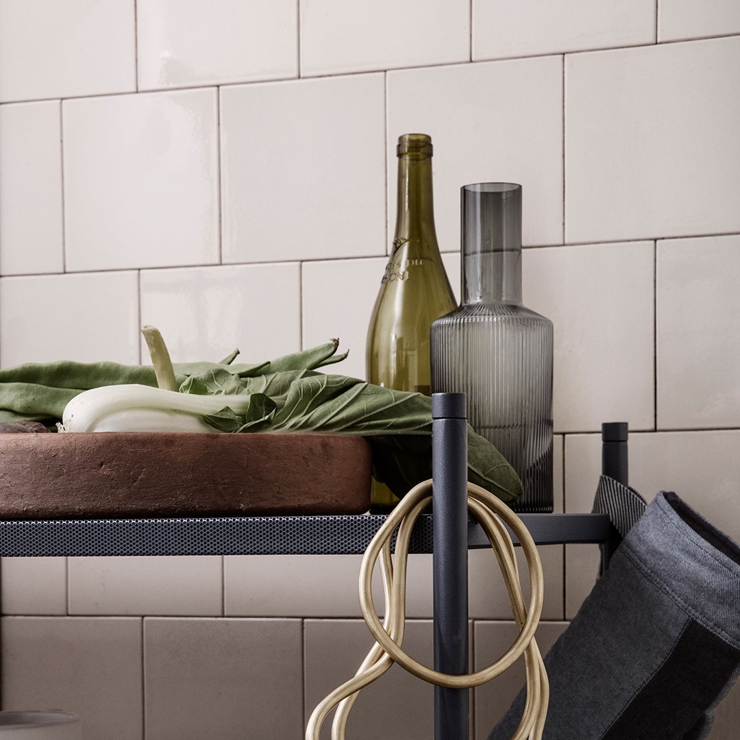"Modern kitchen shelf with earthy tones, gray accents, and organic vegetable patterns."