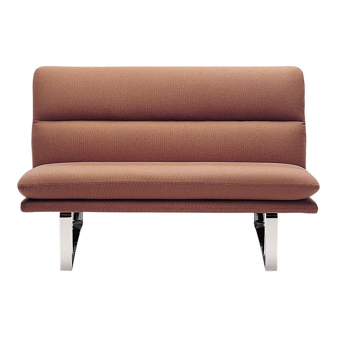 Brown upholstered loveseat with sleek chrome legs and a minimalist design, featuring smooth, modern lines.