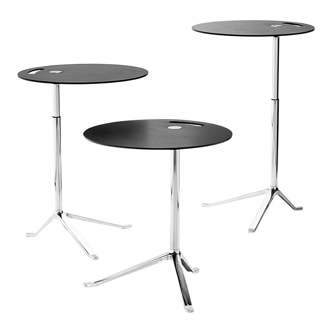 Black round tabletops with sleek chrome legs, featuring a minimalist design and modern aesthetic.