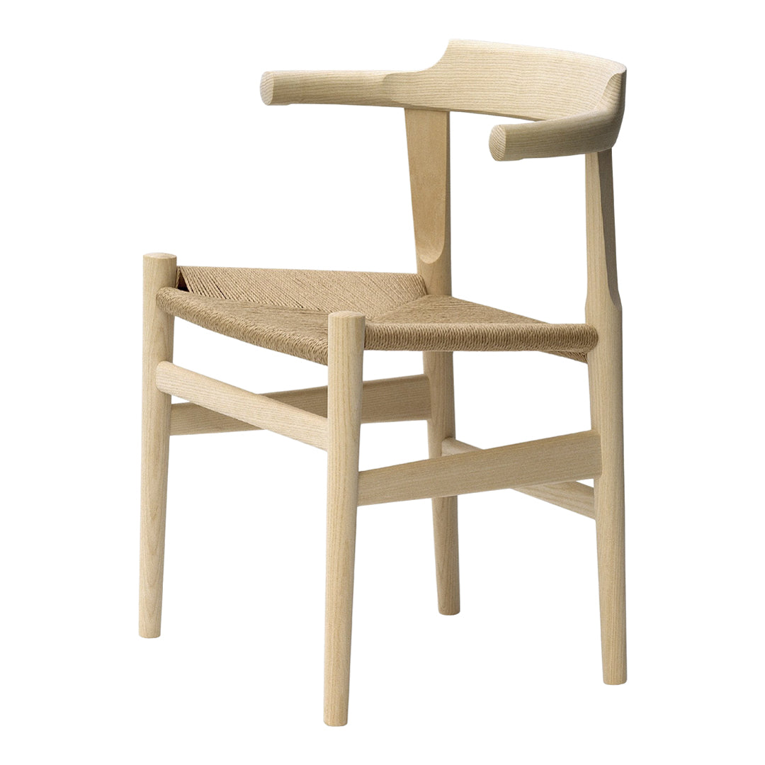 Light wooden chair with a natural woven seat, featuring a minimalist design and neutral color palette.