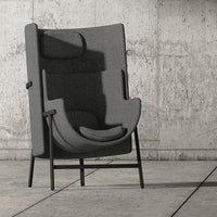 Modern gray upholstered chair with a minimalist design, featuring a sleek black metal frame and smooth contours.