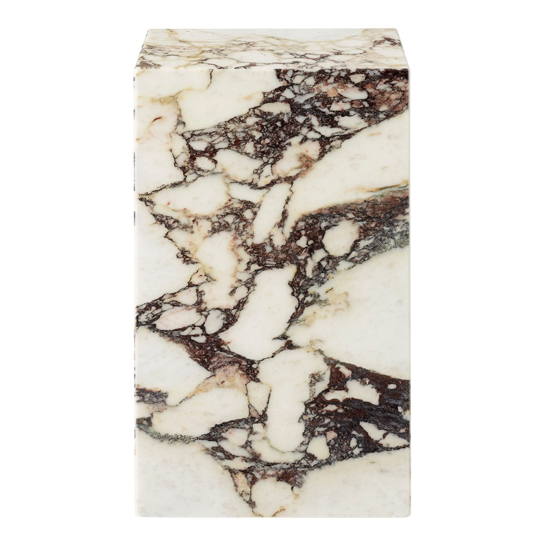White marble block with striking brown and black veining patterns, perfect for modern decor.