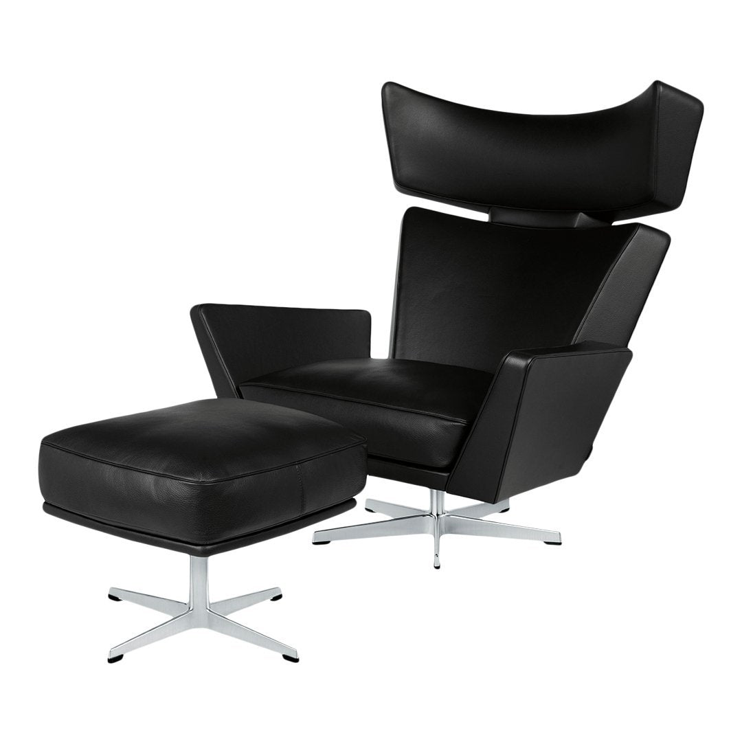Stylish black leather chair and ottoman with sleek silver metal base, featuring a modern, minimalist design.