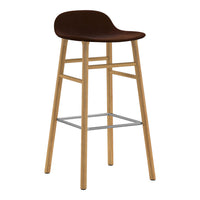 Brown upholstered bar stool with natural wood legs and a silver footrest, featuring a smooth, minimalist design.