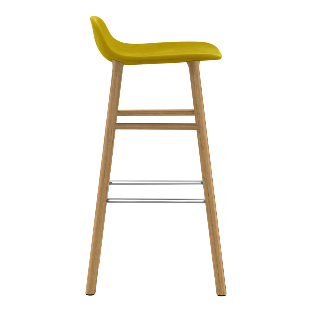 Yellow molded seat bar stool with natural wood legs and a minimalist design. Perfect for modern decor.