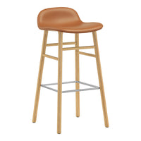 Tan leather bar stool with a natural wood base and metal footrest, featuring a smooth, minimalist design.