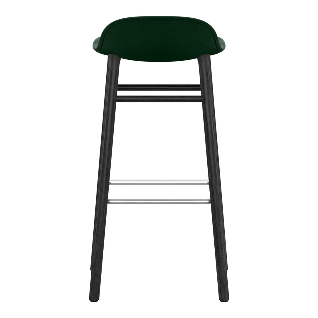 "Green upholstered bar stool with a sleek black wooden frame and silver footrest."