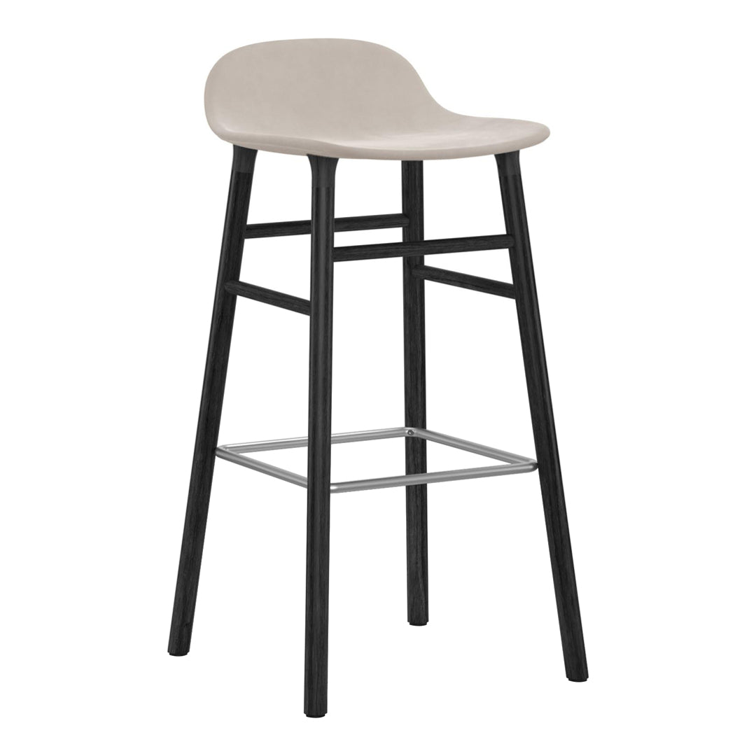 Light beige bar stool with a smooth seat and black wooden legs, featuring a silver footrest for contrast.