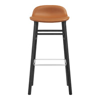 Brown leather bar stool with a sleek black frame and silver footrest. Modern, minimalist design for any space.