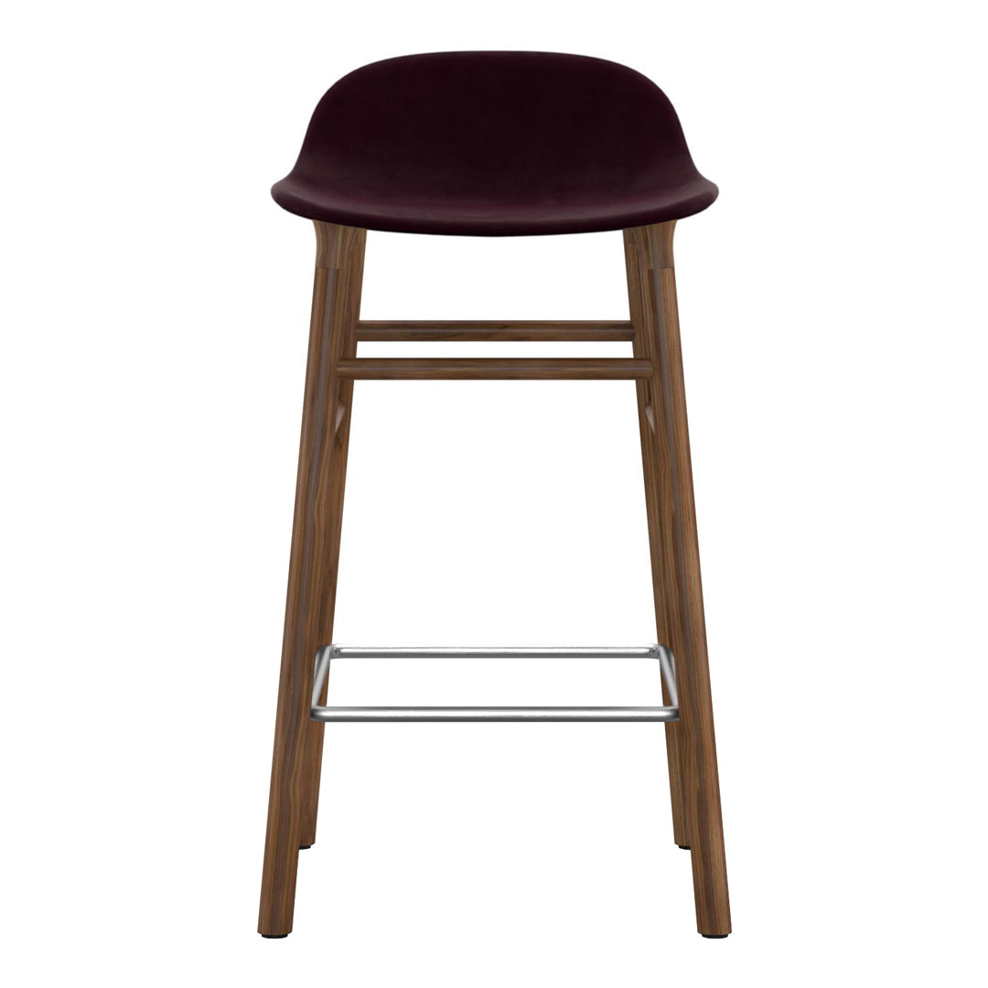 Burgundy velvet barstool with natural wood frame and silver footrest, featuring a sleek, modern design.