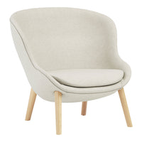 Light beige upholstered chair with smooth curves and natural wood legs, perfect for a modern living space.
