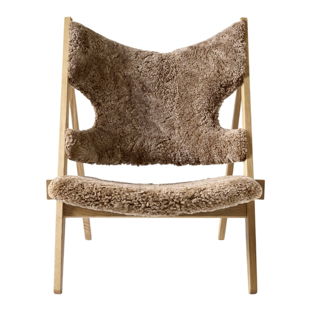 Brown textured chair with a soft, fuzzy surface and natural wood frame, showcasing a cozy and modern design.