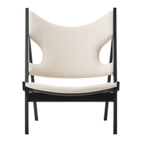 Neutral beige upholstery with a minimalist black frame; modern and stylish chair design.