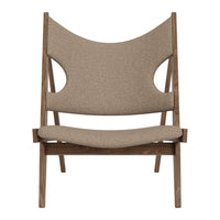 Brown upholstered chair with a unique cut-out pattern and a modern wooden frame. Perfect for contemporary decor.
