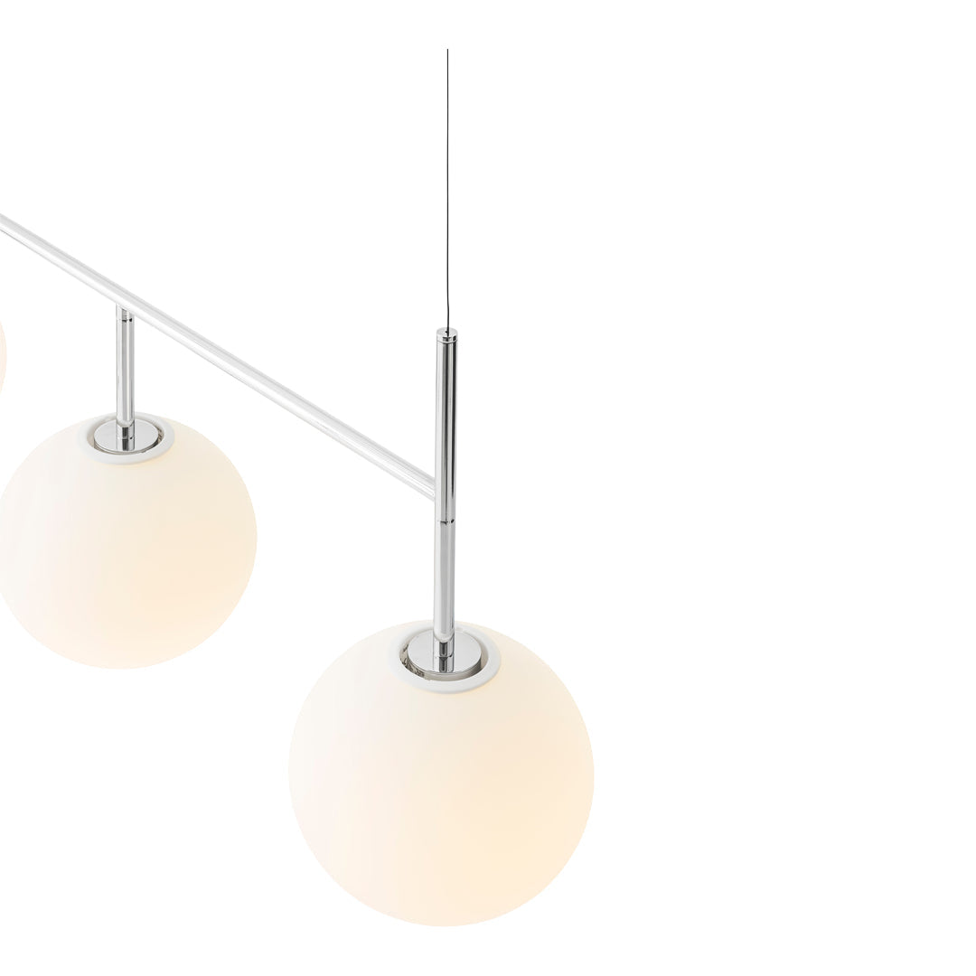 Minimalist pendant light featuring white glass globes and sleek chrome accents for a modern touch.
