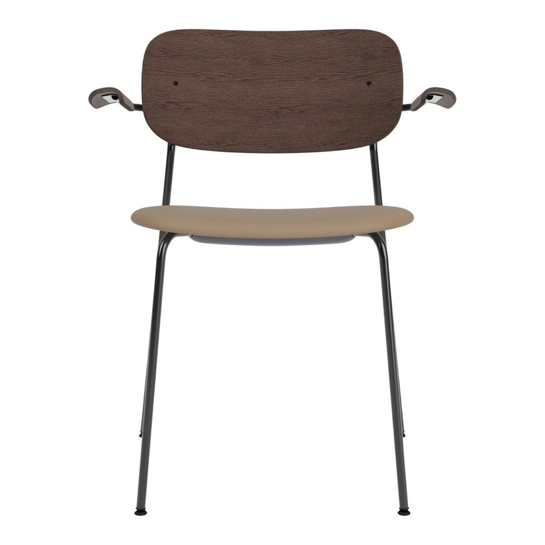Brown wooden backrest and beige seat on a sleek black metal frame chair. Modern and minimalistic design.