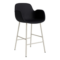 Black upholstered bar stool with minimalist design and sleek white metal legs. Perfect for modern decor styles.
