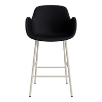 Black cushioned bar stool with a minimalist design and white metal legs. Perfect for modern interiors.