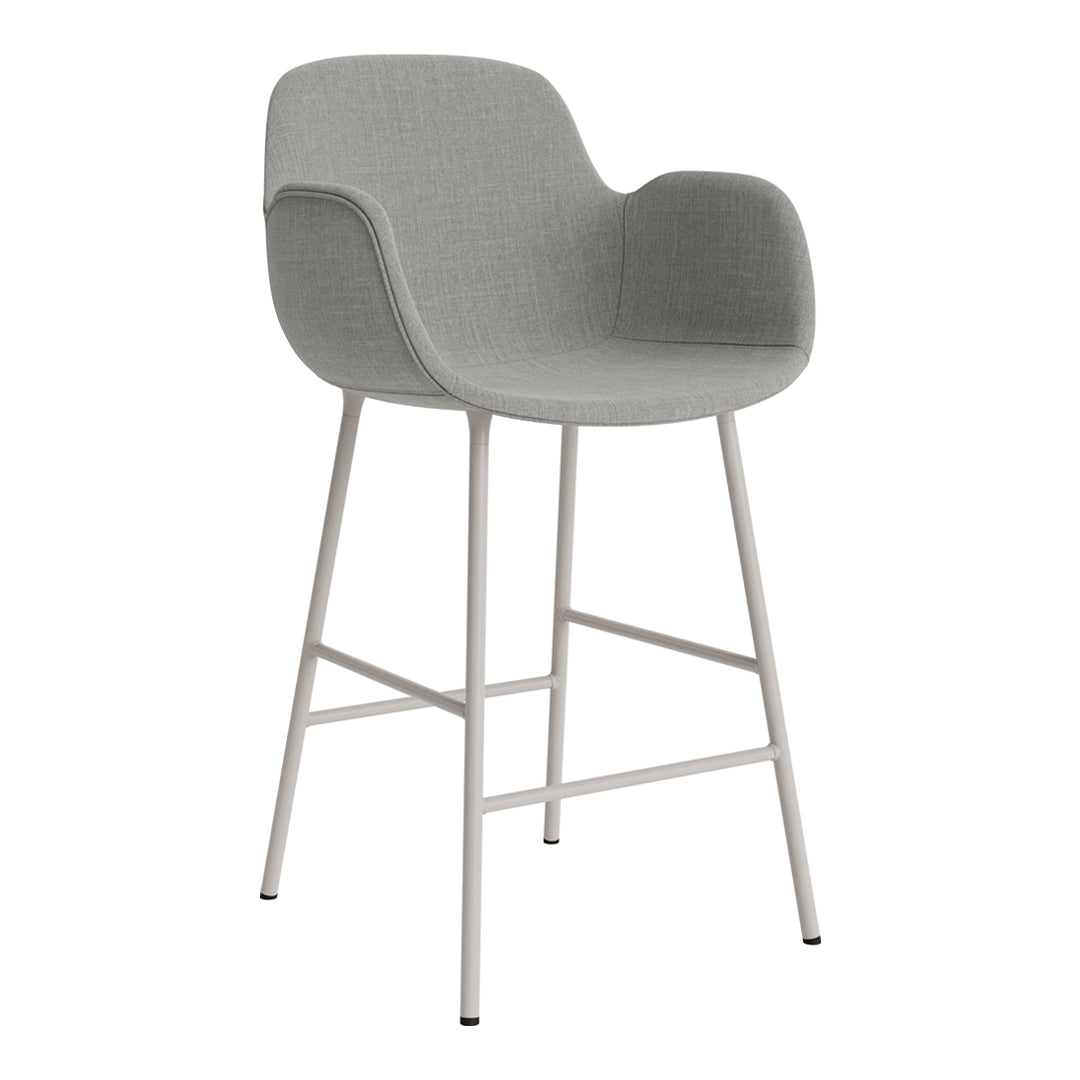 Gray upholstered bar stool with smooth surface and minimalist white metal legs. Modern design for any decor.