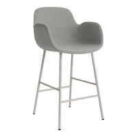 Gray upholstered bar stool with smooth surface and minimalist white metal legs. Modern design for any decor.