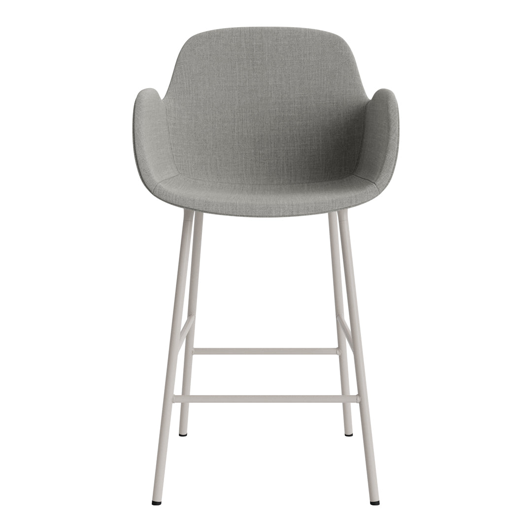 Gray upholstered bar stool with a smooth texture and minimalist white metal legs. Perfect for modern decor.