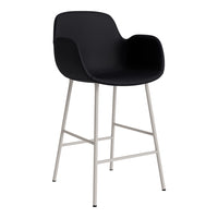 Black bar stool with smooth contours and a sleek silver base, perfect for modern decor.