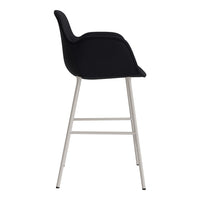 Stylish black upholstered chair with sleek silver metal legs, perfect for modern decor.