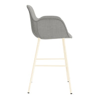 Gray padded bar stool with a minimalistic design and light wood legs, showcasing modern, neutral tones.