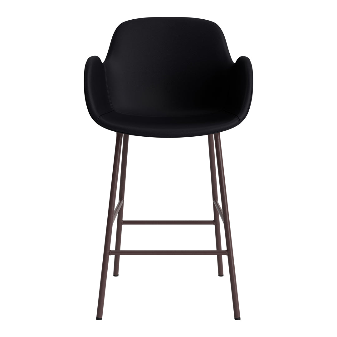 Black bar stool with a sleek design and a matte finish, featuring a minimalist pattern on rust-colored metal legs.