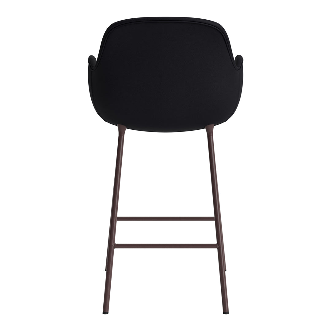Black upholstered stool with a minimalist design and brown metal legs, perfect for modern decor.