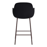Black upholstered stool with a minimalist design and brown metal legs, perfect for modern decor.