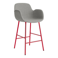 Gray upholstered bar stool with a sleek design and vibrant red metal legs. Modern and stylish accent for any space.