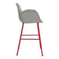 Gray upholstered bar stool with a sleek, modern design and vibrant red metal legs.