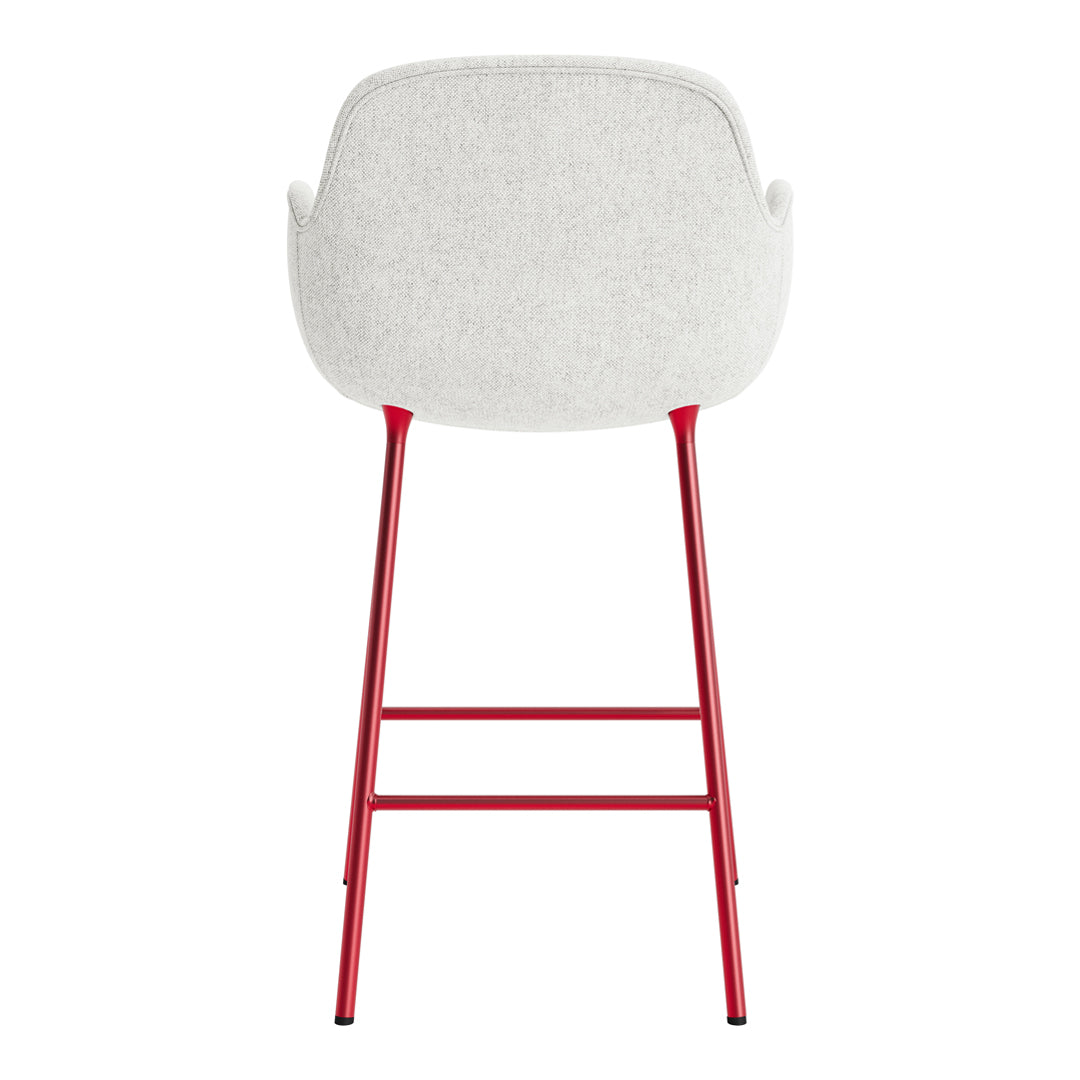 White upholstered chair with a textured finish and sleek red metal legs, offering a modern and stylish design.