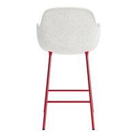 White upholstered chair with a textured finish and sleek red metal legs, offering a modern and stylish design.