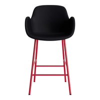 Black upholstered bar stool with sleek red metal legs and a modern minimalist design. Perfect for contemporary spaces.