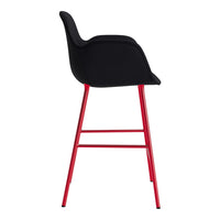 Black upholstered bar stool with sleek lines and vibrant red metal legs. Modern design for stylish interiors.