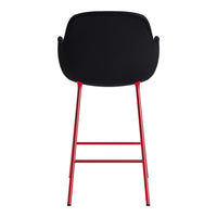 Black bar stool with a sleek, minimalist design and vibrant red legs, adding a pop of color to any space.