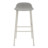 Gray upholstered bar stool with a minimalist design and light-colored metal legs, perfect for modern decor.