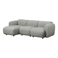 Light gray sectional sofa with smooth, minimalist design and soft, textured fabric. Perfect for modern living spaces.