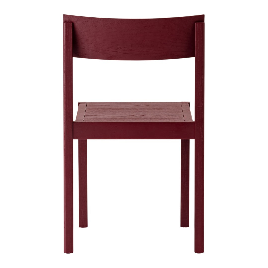 "Back view of a deep burgundy wooden chair with a sleek, minimalist design."