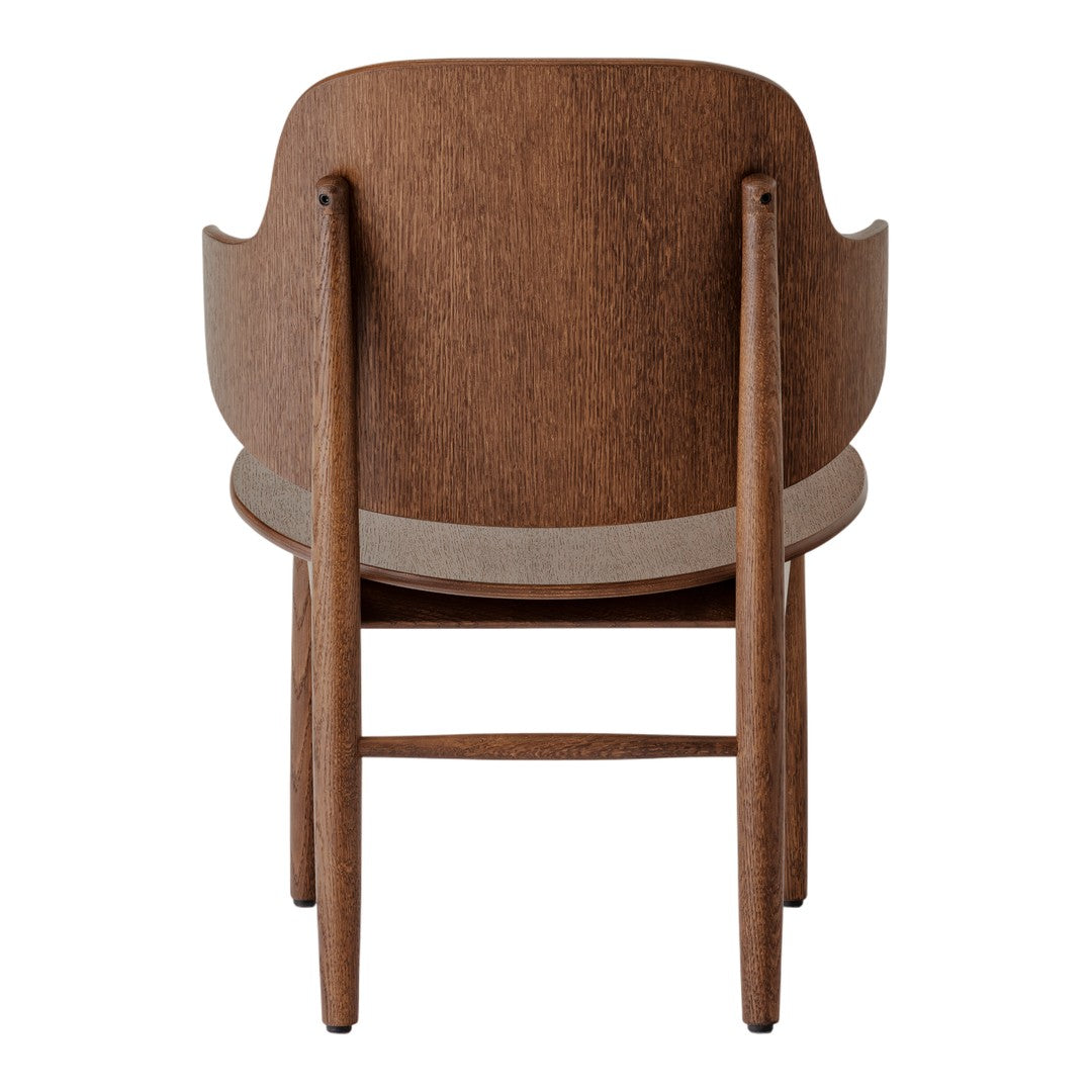 Brown wooden chair with a smooth finish and minimalist design; features soft curved lines and neutral tones.