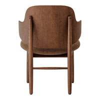 Brown wooden chair with a textured back and natural finish, featuring soft curves and minimalist design.