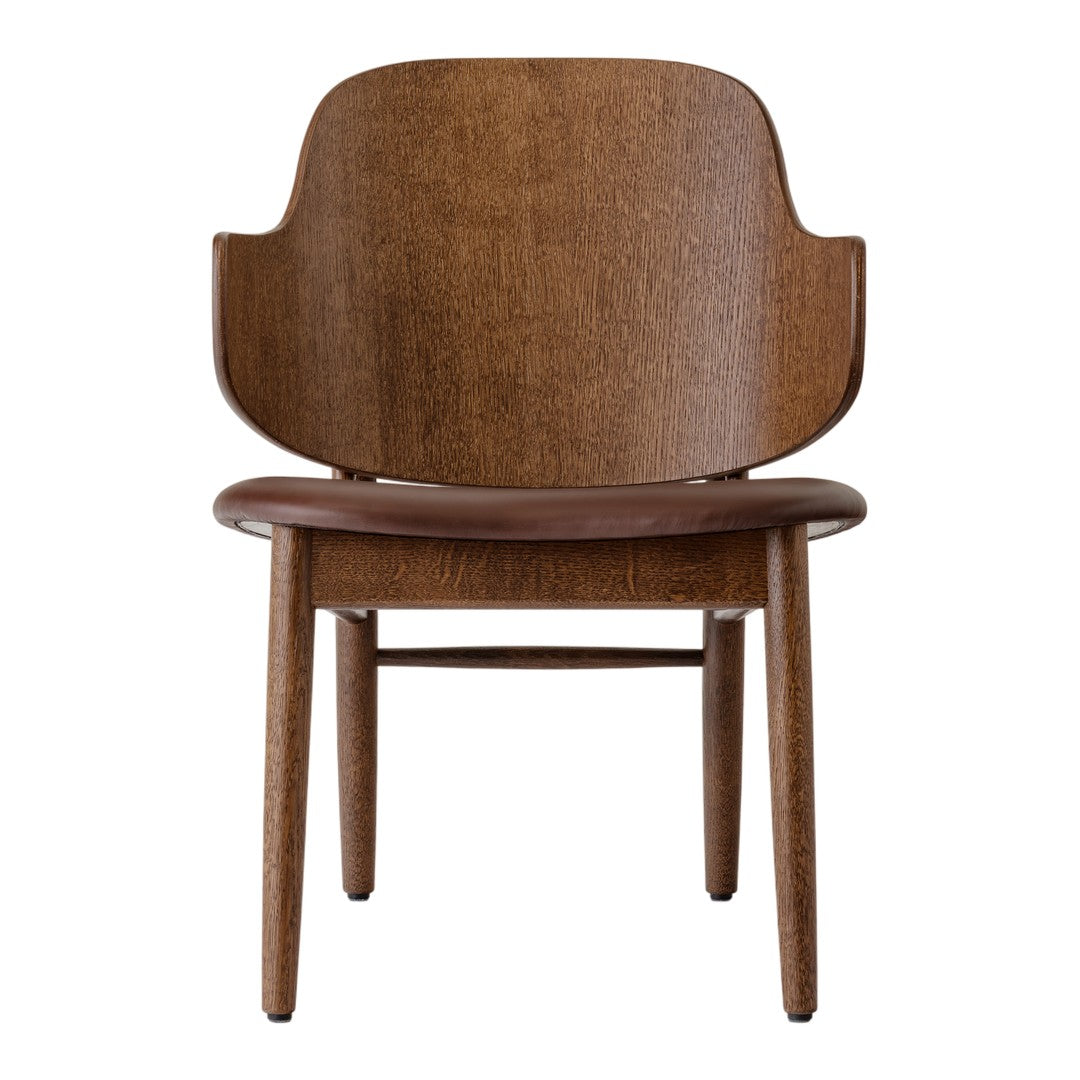 Brown wooden chair with a smooth finish and minimalist design, featuring a rounded back and tapered legs.