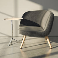 Grey upholstered chair with a textured pattern, complemented by light wooden legs and a minimalist white side table.